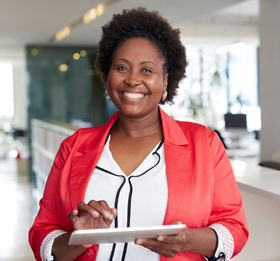 woman smiling holding a tablet